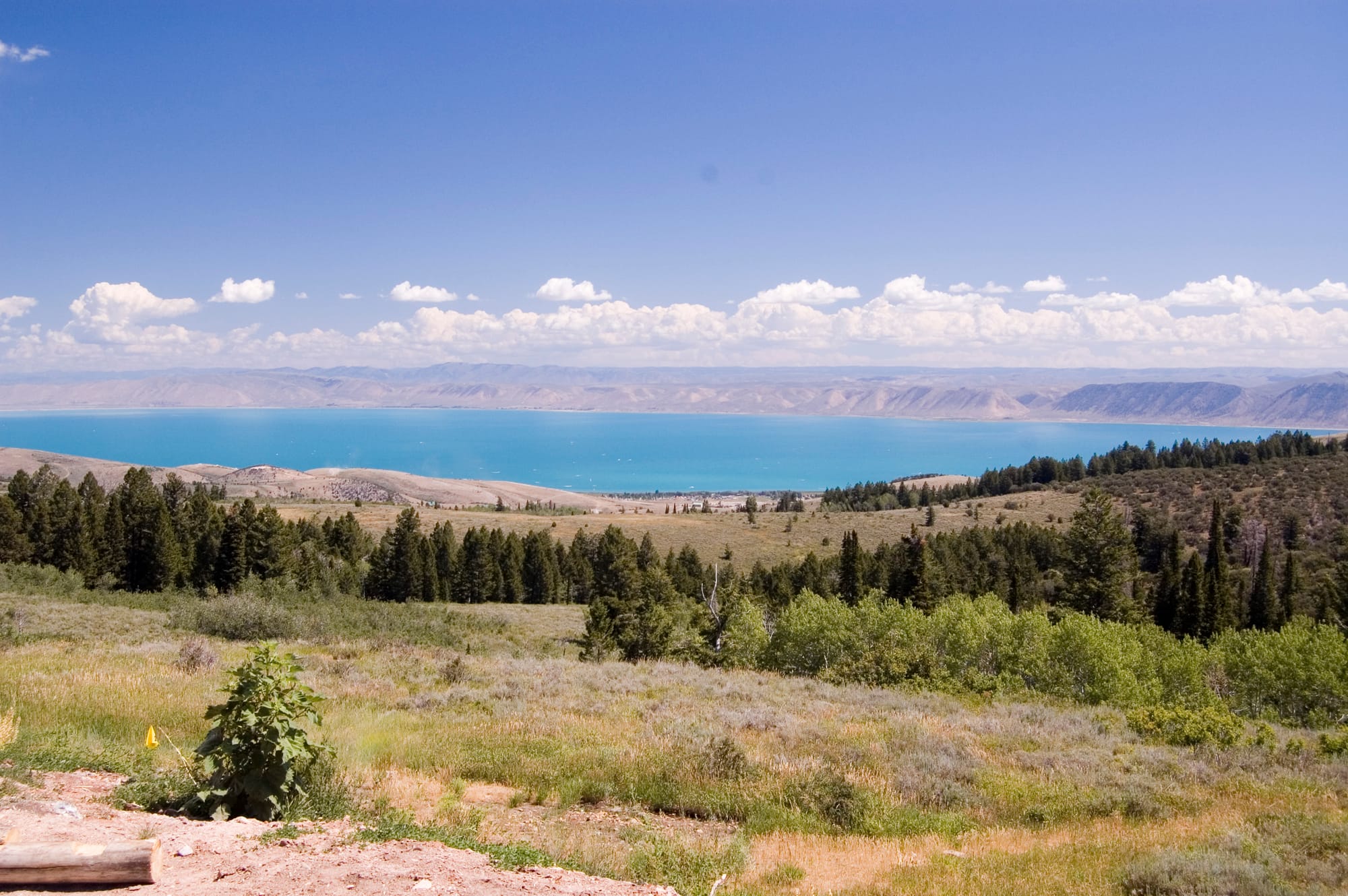 Bear Lake seen from the hills above the west shore, its water bright turquoise against the dry ridges on the far side