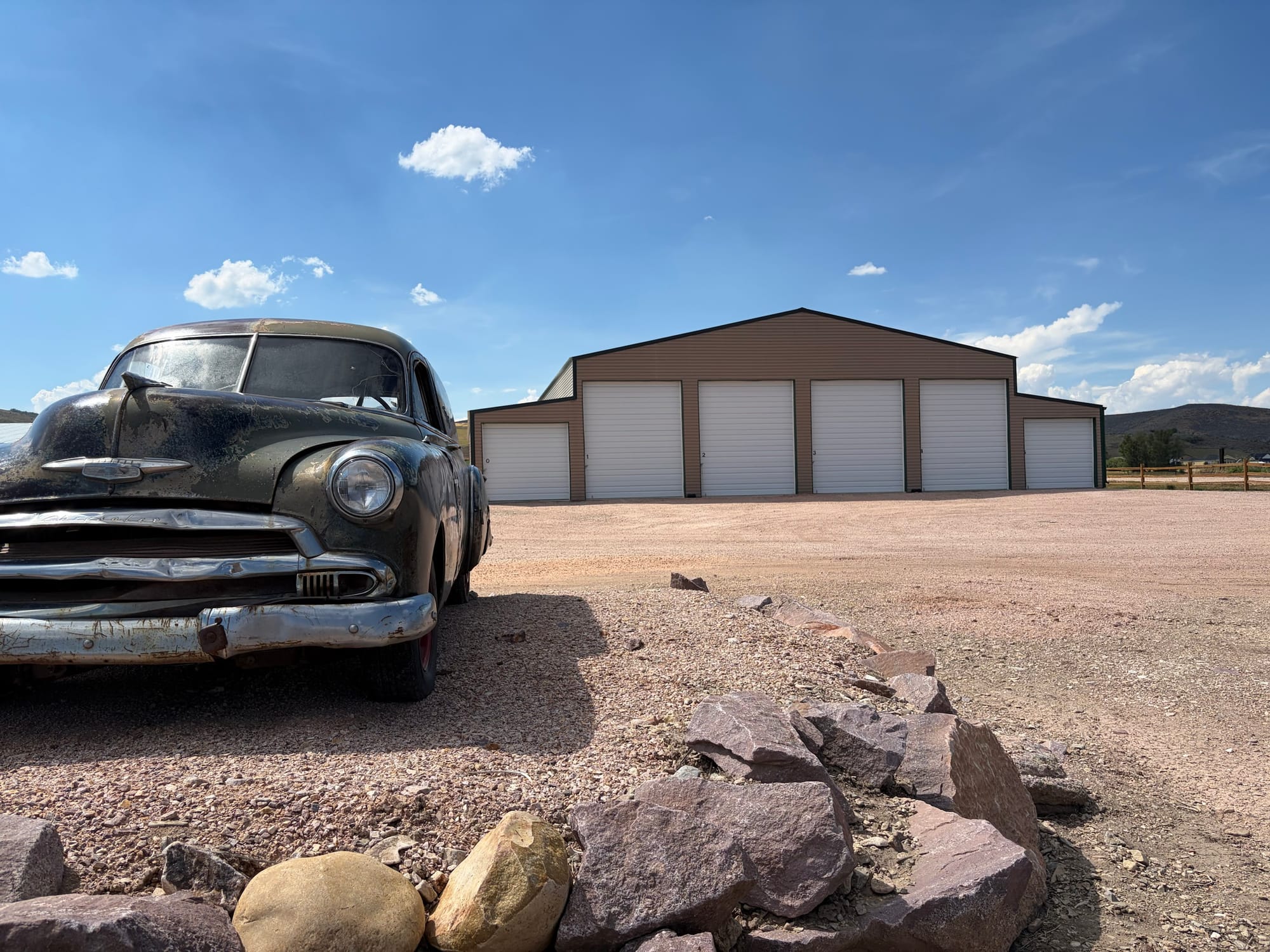 Drive-up storage bays at Paris Creek Storage in Paris, Idaho, with a vintage Chevrolet parked in the foreground
